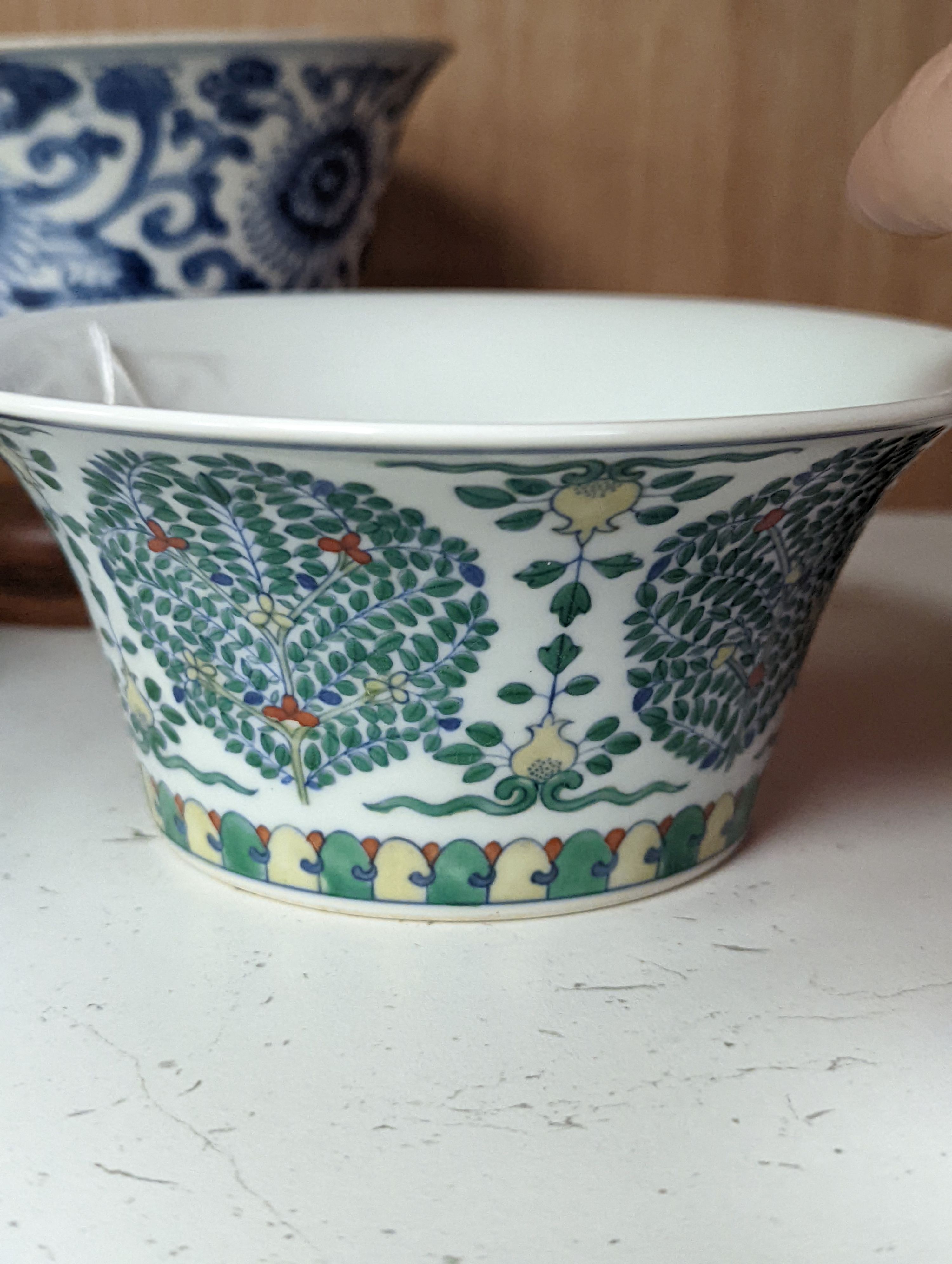A Chinese blue and white bowl, Kangxi, 15cm. diam., a famille rose teapot stand, Yongzheng, and two doucai bowls